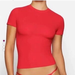 Skims red shirt